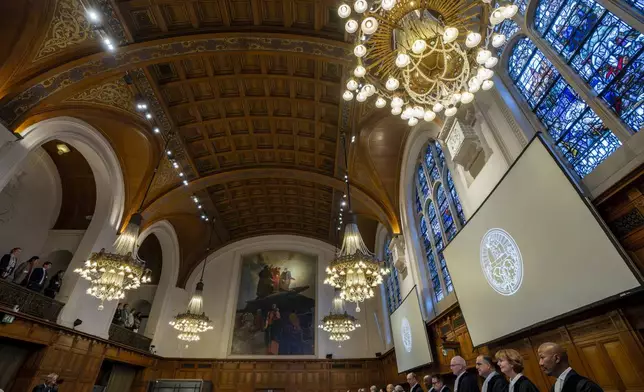 Judges at the International Court of Justice in The Hague, Netherlands, prepare to open hearings into what countries worldwide are legally required to do to combat climate change and help vulnerable nations fight its devastating impact, Monday, Dec. 2, 2024. (AP Photo/Peter Dejong)