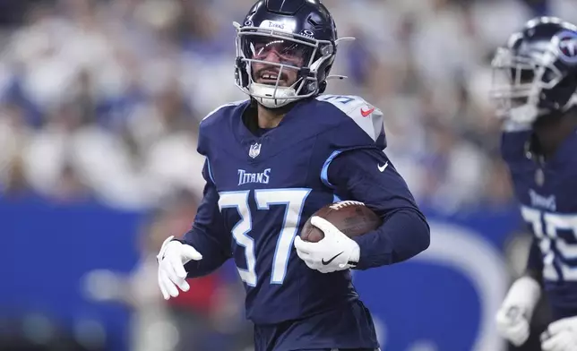 Tennessee Titans safety Amani Hooker (37) celebrates his interception during the first half of an NFL football game against the Indianapolis Colts, Sunday, Dec. 22, 2024, in Indianapolis. (AP Photo/Michael Conroy)