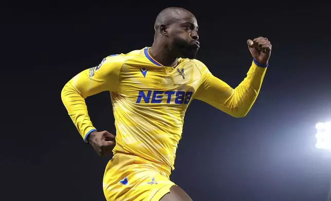 Crystal Palace's Jean-Philippe Mateta celebrates after scoring the opening goal during the England Premier League soccer match between Ipswich Town and Crystal Palace at Portman Road, Ipswich, England, Tuesday, Dec. 3, 2024. (Zac Goodwin/PA via AP)