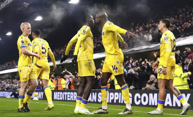 Crystal Palace's Jean-Philippe Mateta, second right, celebrates with teammates after scoring the opening goal during the England Premier League soccer match between Ipswich Town and Crystal Palace at Portman Road, Ipswich, England, Tuesday, Dec. 3, 2024. (Zac Goodwin/PA via AP)