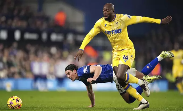 Crystal Palace's Jean-Philippe Mateta, right, challenges with Ipswich Town's Jacob Greaves to score the opening goal during the England Premier League soccer match between Ipswich Town and Crystal Palace at Portman Road, Ipswich, England, Tuesday, Dec. 3, 2024. (Zac Goodwin/PA via AP)