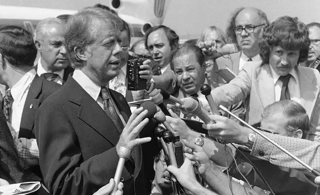 FILE - Then Democratic presidential nominee Jimmy Carter speaks to reporters on his arrival at Hobby International Airport in Houston on Sept. 24, 1976. (AP Photo/Jack Thornell, File)