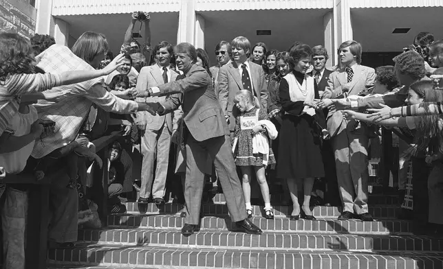 FILE - Democratic Presidential candidate Jimmy Carter and his wife Rosalynn Carter greet people after attending church services at the University Baptist Church near the end of his presidential election campaign on Oct. 31, 1976, in Fort Worth, Texas. (AP Photo/John Duricka, File)