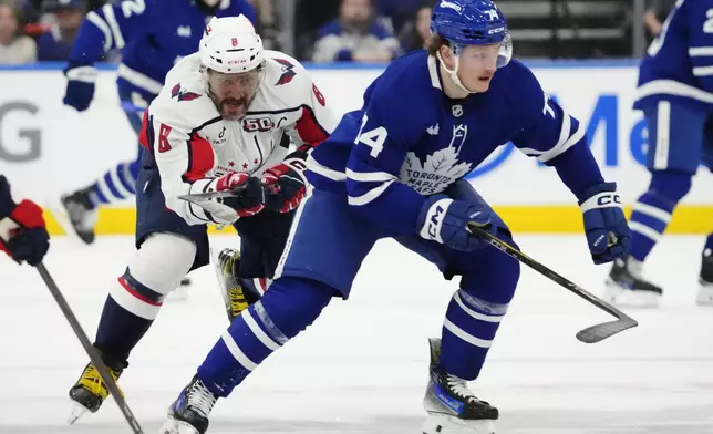 Washington Capitals' Alex Ovechkin (8) chases Toronto Maple Leafs' Bobby McMann (74) during second-period NHL hockey game action in Toronto, Saturday, Dec. 28, 2024. (Frank Gunn/The Canadian Press via AP)