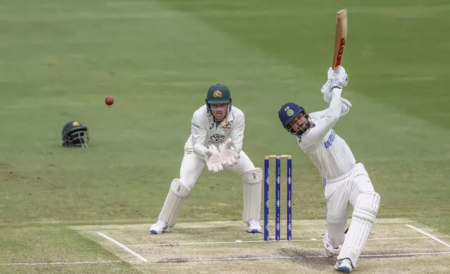 India's Akash Deep plays a shot during play on day five of the third cricket test between India and Australia at the Gabba in Brisbane, Australia, Wednesday, Dec. 18, 2024. (AP Photo/Pat Hoelscher)