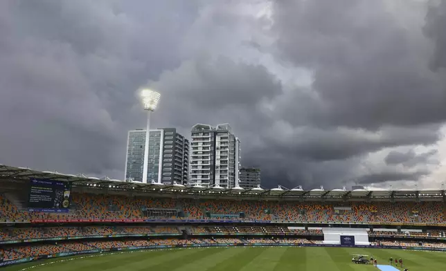 Rain clouds hover above the Gaba as rain interrupts the play on day five of the third cricket test between India and Australia at the Gabba in Brisbane, Australia, Wednesday, Dec. 18, 2024. (AP Photo/Pat Hoelscher)