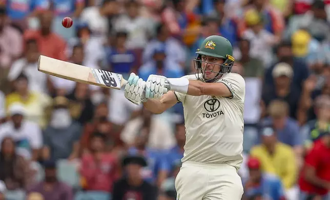 Australia's captain Pat Cummins hits a six during play on day five of the third cricket test between India and Australia at the Gabba in Brisbane, Australia, Wednesday, Dec. 18, 2024. (AP Photo/Pat Hoelscher)