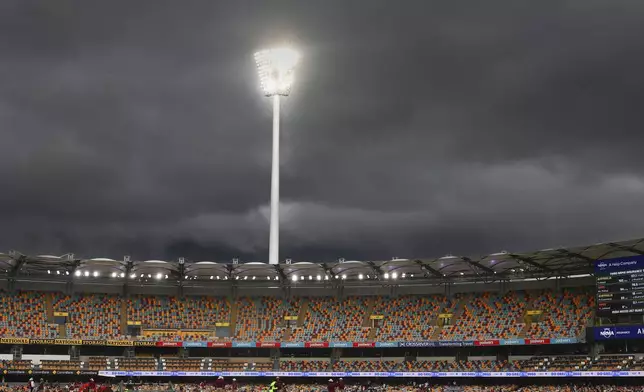 Rain clouds hover above the Gaba as rain interrupts the play on day five of the third cricket test between India and Australia at the Gabba in Brisbane, Australia, Wednesday, Dec. 18, 2024. (AP Photo/Pat Hoelscher)