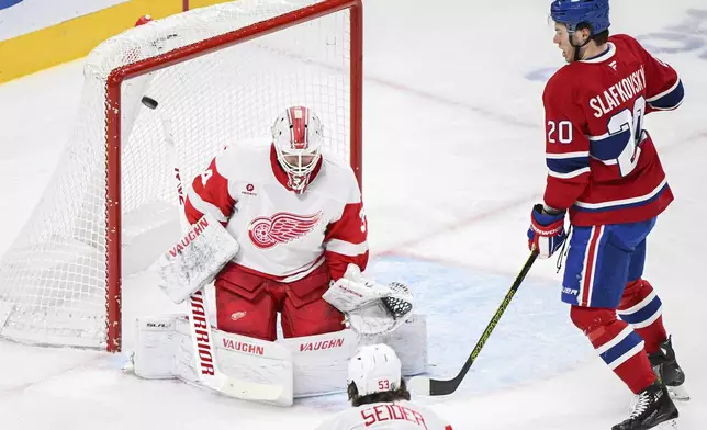 Montreal Canadiens' Juraj Slafkovsky (20) looks on as the puck gets past Detroit Red Wings goaltender Alex Lyon for a goal during the first period of an NHL hockey game in Montreal, Saturday, Dec. 21, 2024. (Graham Hughes/The Canadian Press via AP)