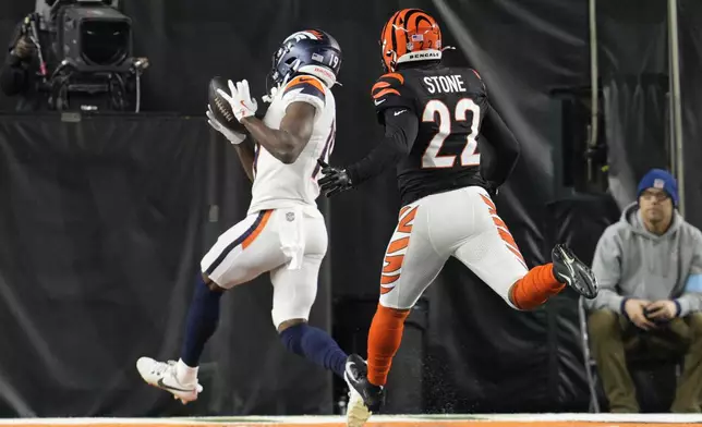 Denver Broncos wide receiver Marvin Mims Jr. (19) makes a catch in front of Cincinnati Bengals safety Geno Stone (22) for a touchdown during the second half of an NFL football game in Cincinnati, Saturday, Dec. 28, 2024. (AP Photo/Jeff Dean)