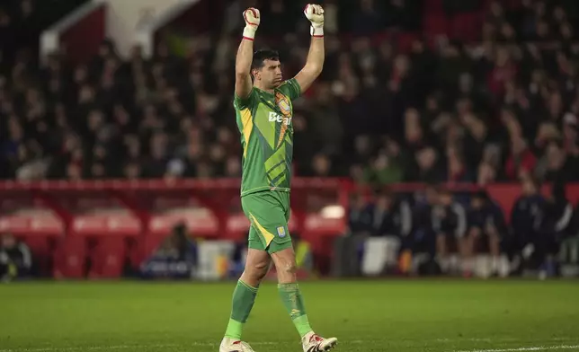 Aston Villa goalkeeper Emiliano Martinez celebrates after teammate Jhon Duran scores a goal against Nottingham Forest during a Premier League soccer match at the City Ground, Saturday Dec 14, 2024, in Nottingham, England. (Joe Giddens/PA via AP)