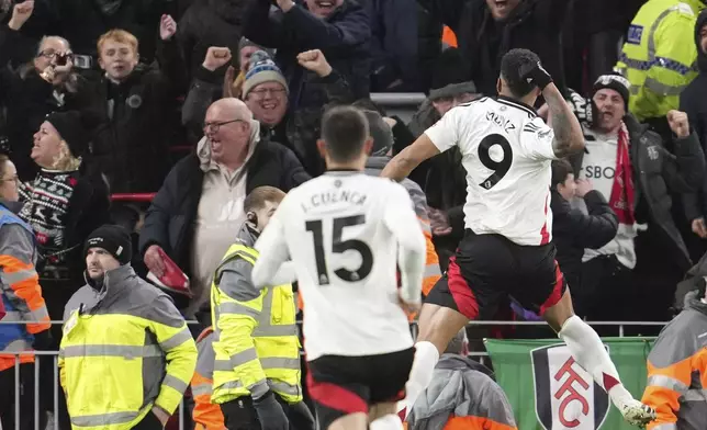 Fulham's Rodrigo Muniz, right, celebrates with teammates after scoring his side's second goal during the English Premier League soccer match between Liverpool and Fulham, at Anfield stadium in Liverpool, England, Saturday, Dec. 14, 2024. (AP Photo/Jon Super)