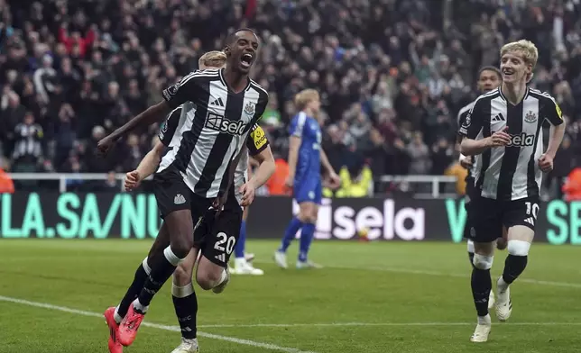 Newcastle United's Alexander Isak, left, celebrates scoring his side's third goal of the game, during the English Premier League soccer match between Newcastle United and Leicester City, at St. James' Park, in Newcastle upon Tyne, England, Saturday, Dec. 14, 2024. (Owen Humphreys/PA via AP)