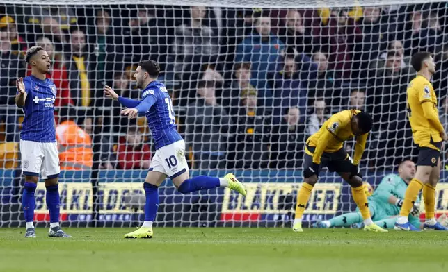 Ipswich Town's Conor Chaplin, second left, celebrates his side's first goal after Wolverhampton Wanderers' Matt Doherty scores an own goal, during the English Premier League soccer match between Wolverhampton Wanderers and Ipswich Town, at Molineux Stadium, in Wolverhampton, Saturday, Dec. 14, 2024. (Nigel French/PA via AP)