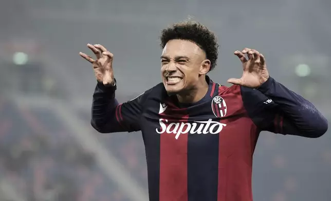 Bologna's Dan Ndoye celebrates after scoring the 1-0 goal for his team during the Serie A soccer match between Bologna and Venezia at Renato Dall'Ara Stadium in Bologna, Italy, Saturday, Nov. 30, 2024. (Massimo Paolone/LaPresse via AP)