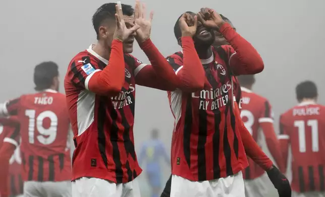 AC Milan's Alvaro Morata, left, celebrates with his teammate Youssouf Fofana after scoring his side's opening goal during the Italian Serie A soccer match between AC Milan and Empoli, at the Milan San Siro stadium, Italy, Saturday, Nov. 30, 2024. (AP Photo/Luca Bruno)