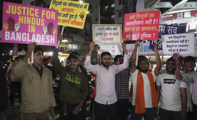 Activists of Bajarang dal, a Hindu rights group, shout slogans during a protest against the alleged attacks on Hindus in Bangladesh, in Ahmedabad, India, Wednesday, Dec. 11, 2024. (AP Photo/Ajit Solanki)