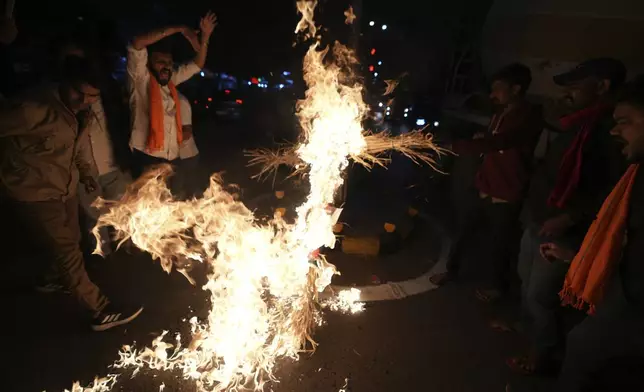 Activists of Bajarang dal, a Hindu rights group, burn an effigy of Bangladesh's interim leader Muhammad Yunus, during a protest against the alleged attacks on Hindus in Bangladesh, in Ahmedabad, India, Wednesday, Dec. 11, 2024. (AP Photo/Ajit Solanki)