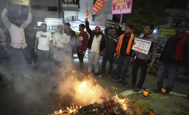 Activists of Bajarang dal, a Hindu rights group, burn an effigy of Bangladesh's interim leader Muhammad Yunus, during a protest against the alleged attacks on Hindus in Bangladesh, in Ahmedabad, India, Wednesday, Dec. 11, 2024. (AP Photo/Ajit Solanki)