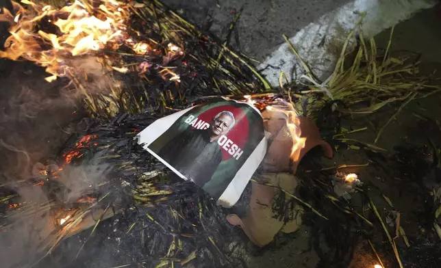 Activists of Bajarang dal, a Hindu rights group, burn an effigy of Bangladesh's interim leader Muhammad Yunus, during a protest against the alleged attacks on Hindus in Bangladesh, in Ahmedabad, India, Wednesday, Dec. 11, 2024. (AP Photo/Ajit Solanki)