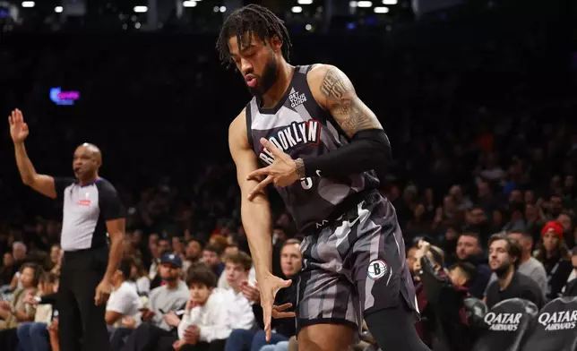 Brooklyn Nets forward Trendon Watford, center, reacts after making a 3-point basket against the Orlando Magic during the first half of an NBA basketball game, Sunday, Dec. 1, 2024, in New York. (AP Photo/Noah K. Murray)