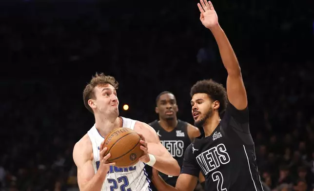 Brooklyn Nets forward Cameron Johnson (2) defends against Orlando Magic forward Franz Wagner (22) during the first half of an Emirates NBA Cup basketball game, Friday, Nov. 29, 2024, in New York. (AP Photo/Noah K. Murray)