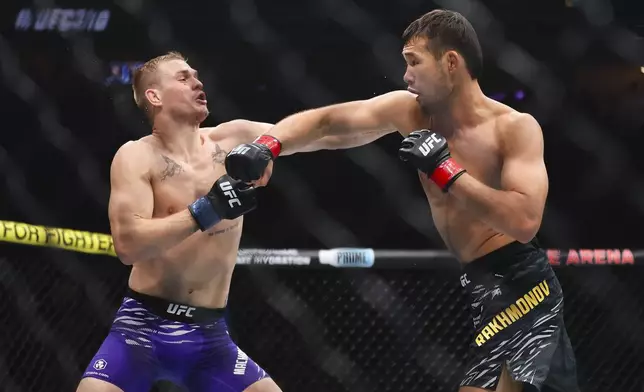Shavkat Rakhmonov, right, punches Ian Machado Garry in a UFC 310 mixed martial arts welterweight bout at T-Mobile Arena, Saturday, Dec. 7, 2024, in Las Vegas. (Wade Vandervort/Las Vegas Sun via AP)