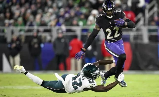 Baltimore Ravens running back Derrick Henry (22) avoids a tackle by Philadelphia Eagles linebacker Oren Burks (42) during the second half of an NFL football game, Sunday, Dec. 1, 2024, in Baltimore. (AP Photo/Nick Wass)