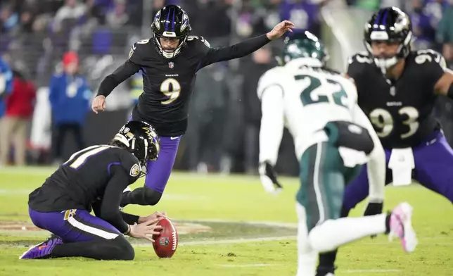 Baltimore Ravens kicker Justin Tucker (9), with Jordan Stout holding, attempts a field goal, which he missed, against the Philadelphia Eagles during the second half of an NFL football game, Sunday, Dec. 1, 2024, in Baltimore. (AP Photo/Stephanie Scarbrough)