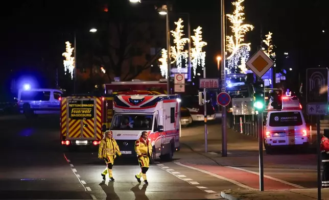 Emergency services work in a cordoned-off area near a Christmas Market, after a car drove into a crowd in Magdeburg, Germany, Saturday, Dec. 21, 2024. (AP Photo/Ebrahim Noroozi)