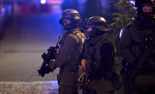 Special police forces attend an incident at the Christmas market in Magdeburg, Germany, Friday Dec. 20, 2024. (Heiko Rebsch/dpa via AP)