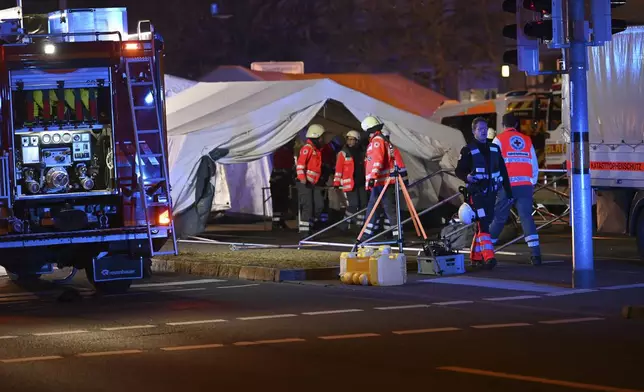 Emergency services attend an incident at the Christmas market in Magdeburg, Germany, Friday Dec. 20, 2024. (Heiko Rebsch/dpa via AP)