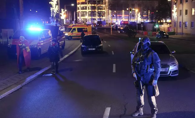 A police officer guards at a cordoned-off area near a Christmas Market after an incident in Magdeburg, Germany, Friday, Dec. 20, 2024. (AP Photo/Ebrahim Noroozi)