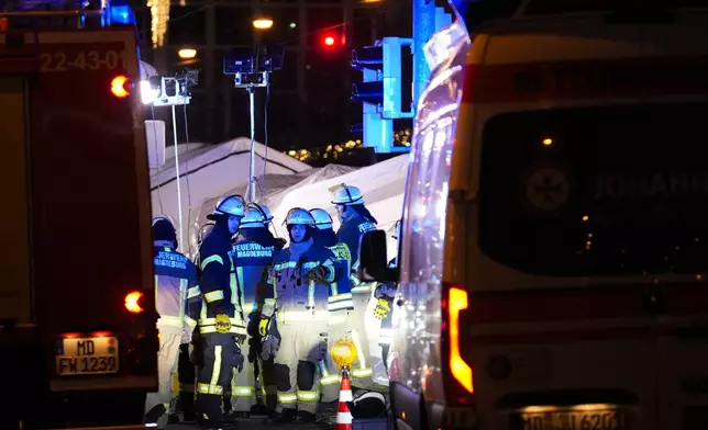 Emergency services work in a cordoned-off area near a Christmas Market, after a car drove into a crowd in Magdeburg, Germany, Friday, Dec. 20, 2024. (AP Photo/Ebrahim Noroozi)