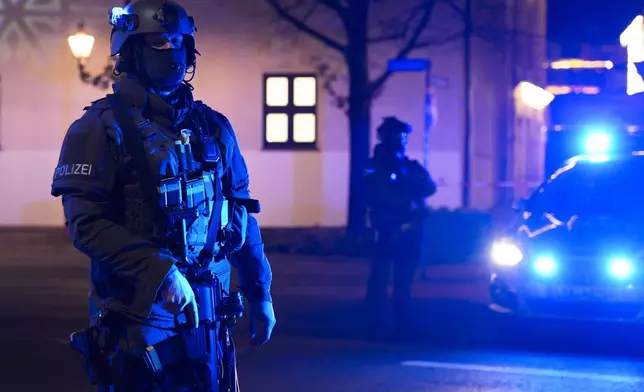 Police officers guard at a cordoned-off area near a Christmas Market after an incident in Magdeburg, Germany, Friday, Dec. 20, 2024. (AP Photo/Ebrahim Noroozi)