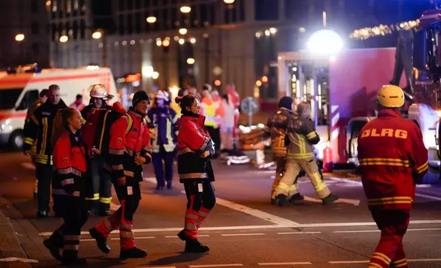 Emergency services work in a cordoned-off area near a Christmas Market, after a car drove into a crowd in Magdeburg, Germany, Friday, Dec. 20, 2024. (AP Photo/Ebrahim Noroozi)