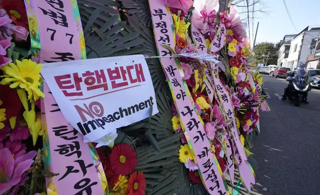 Wreaths sent by supporters of impeached South Korean President Yoon Suk Yeol are displayed outside the Constitutional Court in Seoul, South Korea, Friday, Dec. 27, 2024. (AP Photo/Ahn Young-joon)