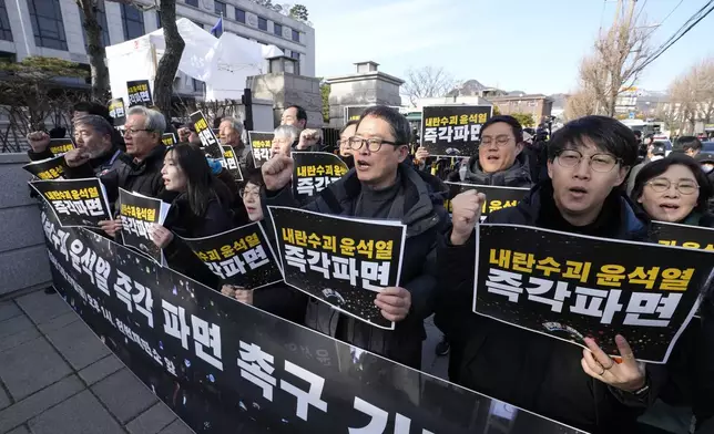 Protesters stage a rally demanding the arrest of impeached South Korean President Yoon Suk Yeol outside of the Constitutional Court in Seoul, South Korea, Friday, Dec. 27, 2024. The signs read, "Fire the rebellion leader Yoon Suk Yeol immediately." (AP Photo/Ahn Young-joon)