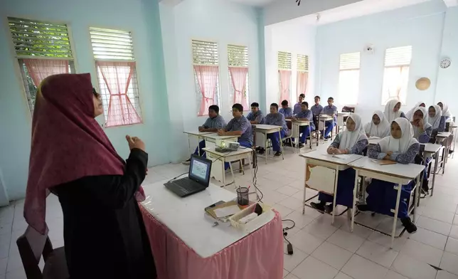 Students attend a class at a school in Banda Aceh, Indonesia, Thursday, Dec. 12, 2024. (AP Photo/Achmad Ibrahim)