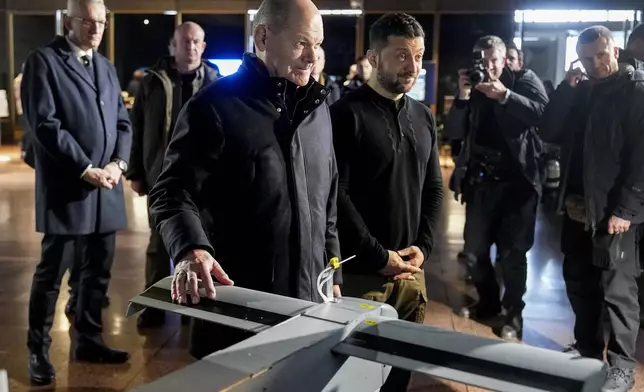 Ukraine's President Volodymyr Zelenskyy, right, and German Chancellor Olaf Scholz take a look at drones during Scholz's visit to Kyiv, Ukraine, Monday, Dec.2, 2024. (AP Photo/Efrem Lukatsky)