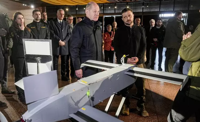 Ukraine's President Volodymyr Zelenskyy, right, and German Chancellor Olaf Scholz take a look at drones during Scholz's visit to Kyiv, Ukraine, Monday, Dec.2, 2024. (AP Photo/Efrem Lukatsky)