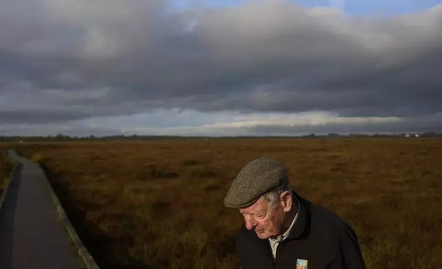 Bog expert Brian Sheridan walks along a boardwalk in the protected Clara Bog Nature Reserve that data center developers consider a potential growth region, in Clara, Ireland, Wednesday, Oct. 16, 2024. (AP Photo/Bram Janssen)