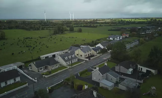 Wind turbines can be seen from the village of Rhode, Ireland, Thursday, Oct. 17, 2024. (AP Photo/Bram Janssen)