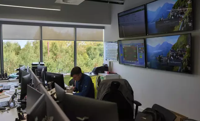 A worker sits inside the control centre of the Digital Realty data center, in Dublin, Ireland, Thursday, Oct. 17, 2024. (AP Photo/Bram Janssen)