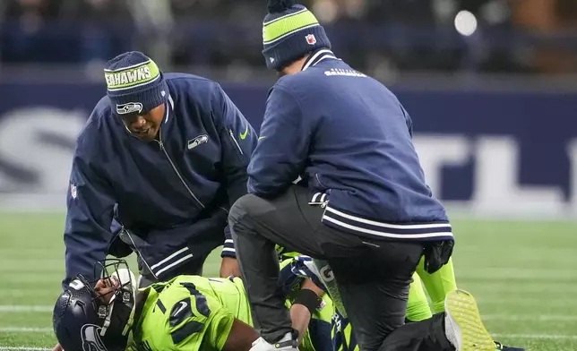 Seattle Seahawks' Geno Smith is hurt during the second half of an NFL football game against the Green Bay Packers Sunday, Dec. 15, 2024, in Seattle. (AP Photo/Lindsey Wasson)