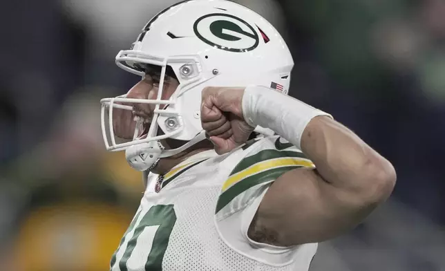 Green Bay Packers' Jordan Love celebrates a touchdown during the first half of an NFL football game against the Seattle Seahawks Sunday, Dec. 15, 2024, in Seattle. (AP Photo/Stephen Brashear)