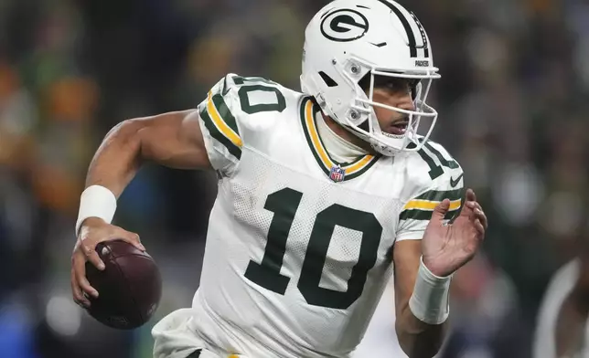 Green Bay Packers' Jordan Love runs during the second half of an NFL football game against the Seattle Seahawks Sunday, Dec. 15, 2024, in Seattle. (AP Photo/Lindsey Wasson)