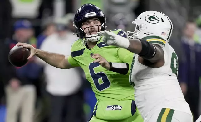 Seattle Seahawks' Sam Howell is pressured by Green Bay Packers' Kenny Clark during the second half of an NFL football game Sunday, Dec. 15, 2024, in Seattle. (AP Photo/Stephen Brashear)