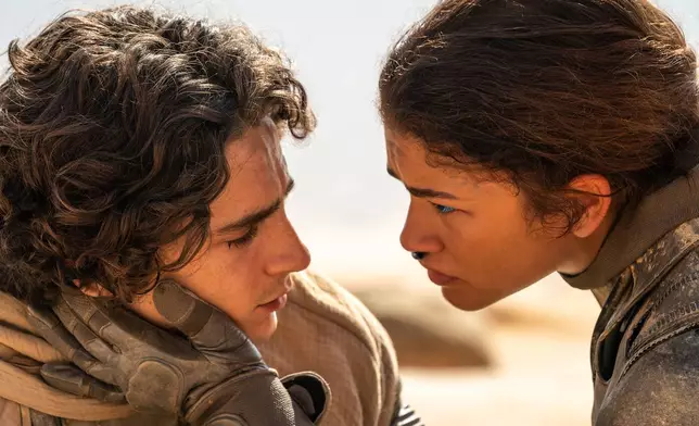 This image released by Warner Bros. Pictures shows Timothee Chalamet, left, and Zendaya in a scene from "Dune: Part Two." (Niko Tavernise/Warner Bros. Pictures via AP)