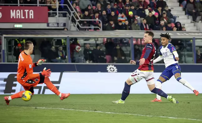 Verona's Amin Sarr, right, scores during the Serie A soccer match between Bologna and Hellas Verona at Renato Dall'Ara Stadium, Bologna, Italy, Monday, Dec. 30, 2024. (Michele Nucci/LaPresse via AP)